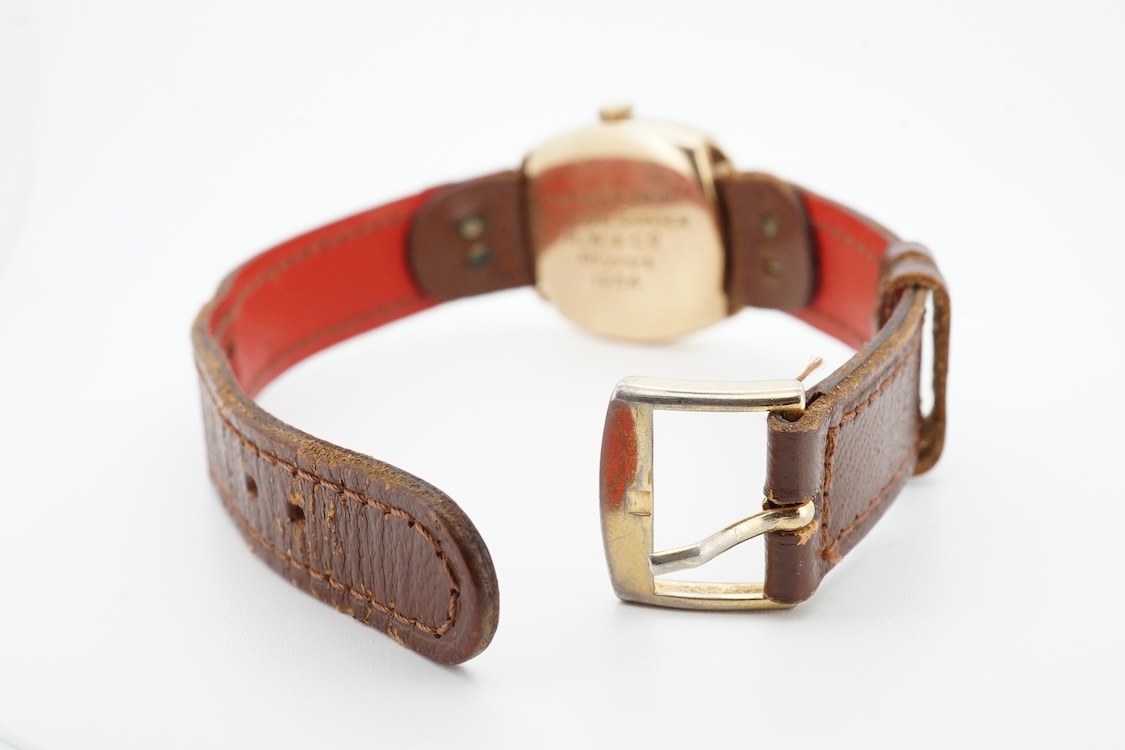 A 1950's 9ct gold Tudor Royal manual wind wrist watch, with Arabic dial, case diameter 27mm, with case back inscription, on a later associated strap.